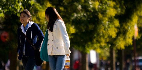 The International Students and Scholars Department. Two people walking outdoors.