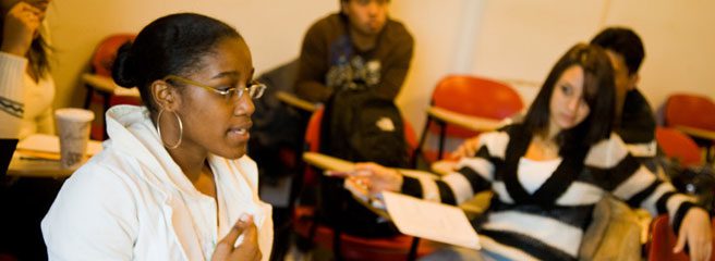 A person speaking in a classroom.