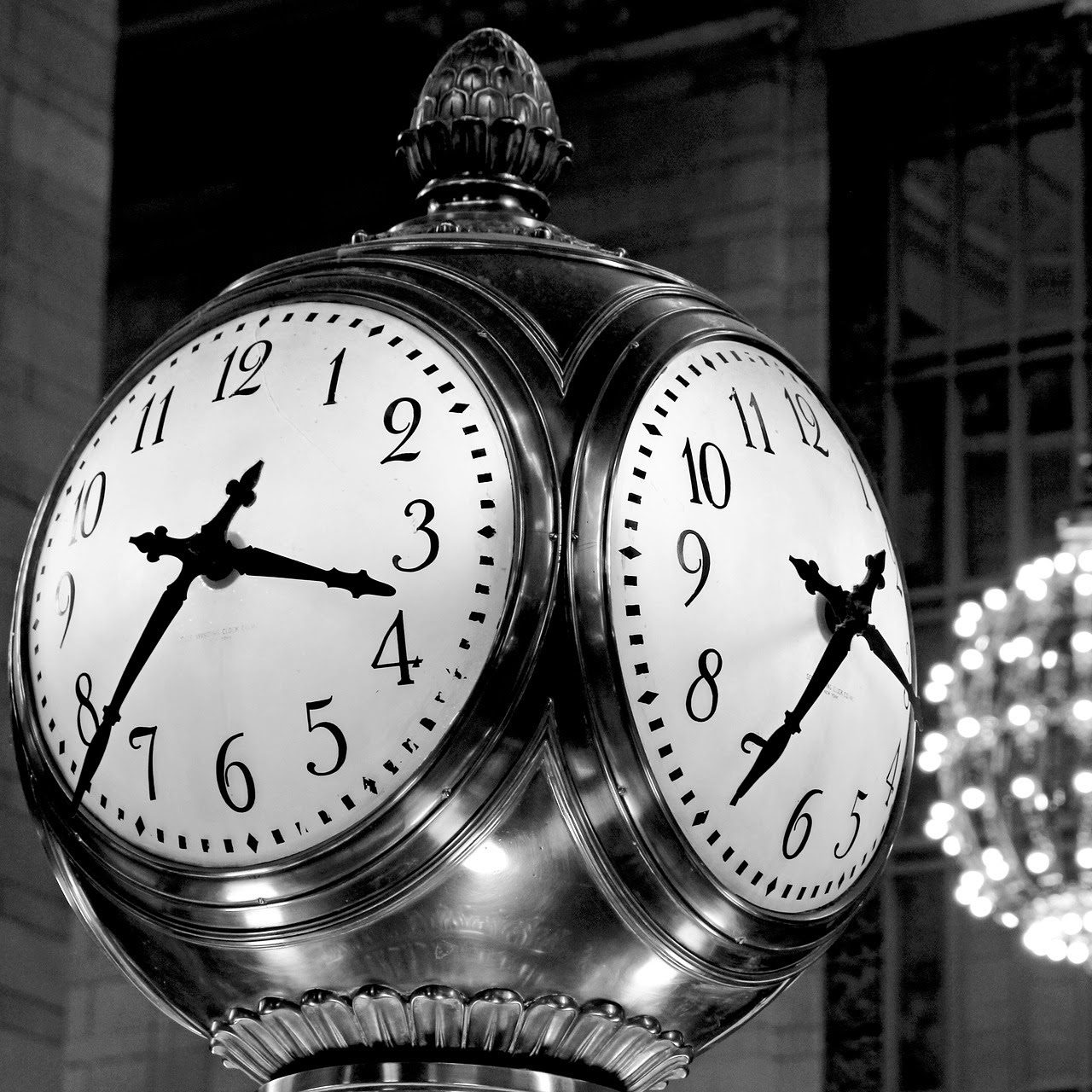 Black and white image of clocks built into a pole.