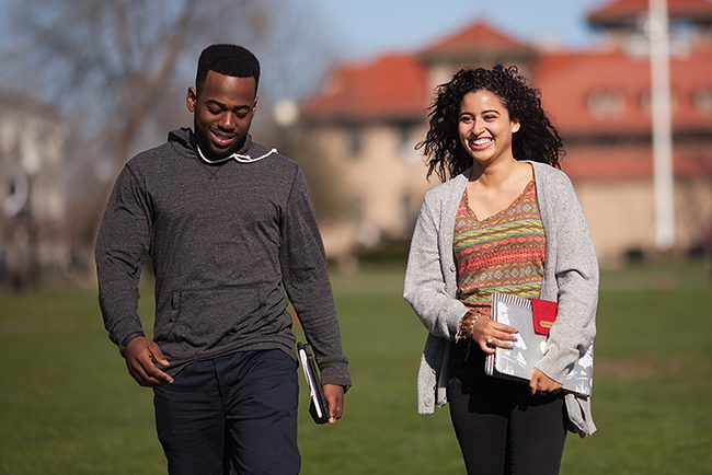 Two people walking on campus. Two people walking on campus.