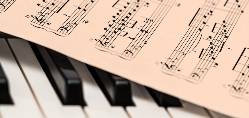A close-up of sheet music on a piano.