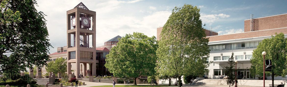 A view of Queens College Campus. The two buildings visible are The Benjamin S. Rosenthal Library on the left-hand side and Powdermaker Hall on the right-hand side.