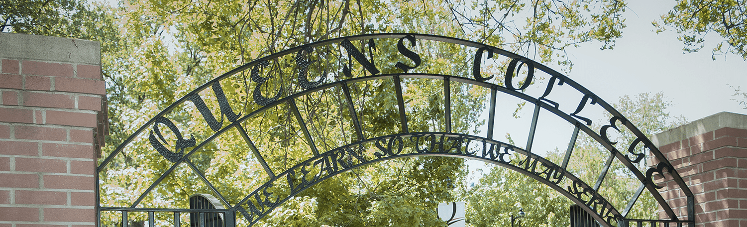 A close-up of the arch of the Queens College entrance. A close-up of the arch of the Queens College entrance. The archway reads Queens College We learn so that we may serve.