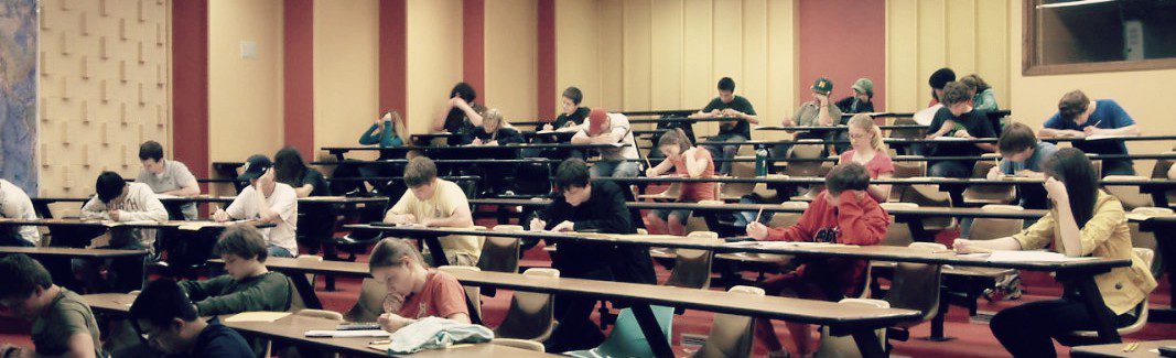 Students taking an exam in a lecture hall.