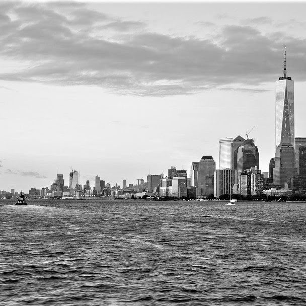 A black and white image of the NYC skyline view over The Hudson River.