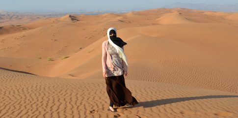 Umussahar "Sahar" Khatri stands amidst the sweeping dunes of Sharqiya during a study abroad trip in the Sultanate of Oman.