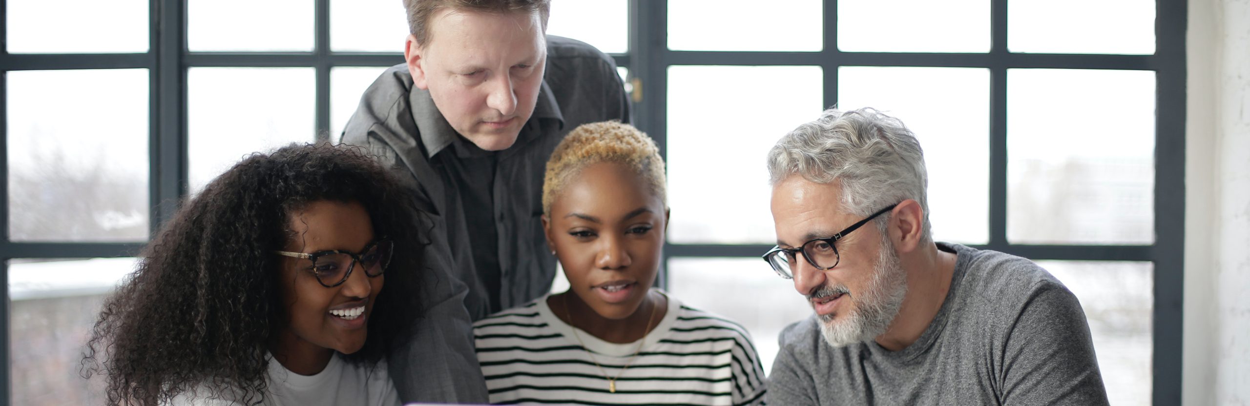 Four people focused on a center point.