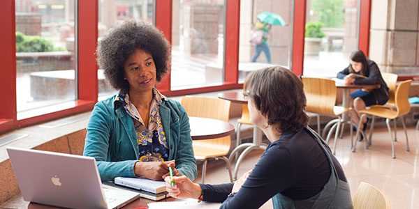 Two people sitting at a table having a conversation.