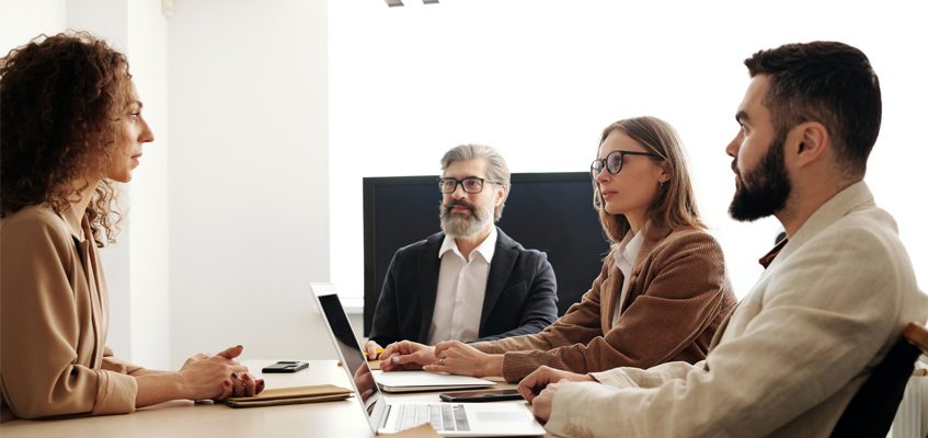 Four people sitting at a table.