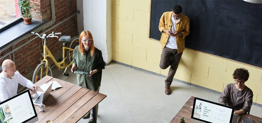 An overhead shot of a classroom with four people.