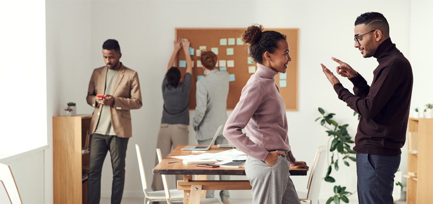 Five people inside of an office setting.