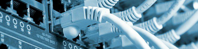 A close-up of ethernet cables plugged into a board. A close-up of ethernet cables plugged into a board.