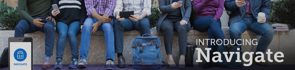 People sitting on a short wall outdoors using their phones.