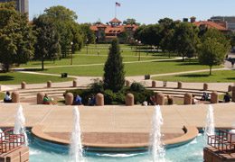 The Quad is a rectangular space with green grass and crisscross walkways. The sides of the quad contain trees.