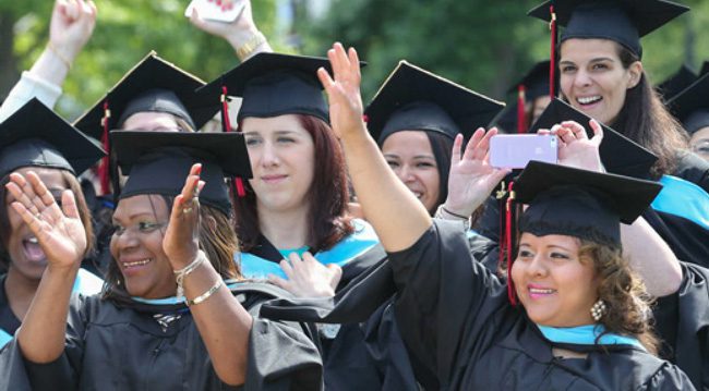 Studenst celebrating wearing caps and gowns