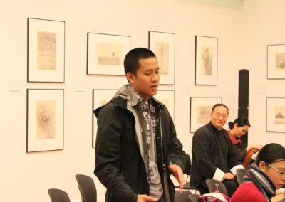 Student Participant standing and speaking while facing the right.
