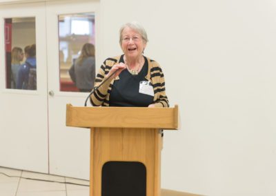 Honoree Professor Bette Weidman, English and American studies, presenting remarks. She is standing behind a podium and speaking into a microphone.