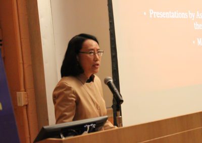 Prof. Hong Wu, Associate Director of AAC talking into a microphone.