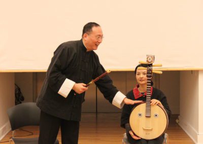 Professor Chen Tao and Professor Liu Li, Melody Dragon Inc holding instruments.