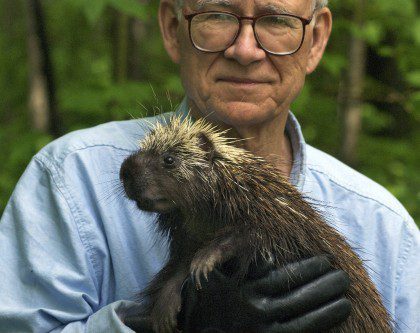 Dr. Uldis Roze holding a porcupine.