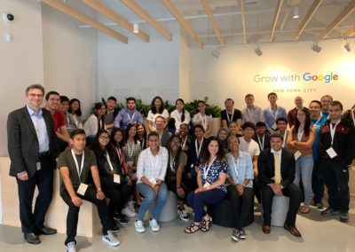 A large group photo. The text “Grow with Google” is visible on the wall in the background.