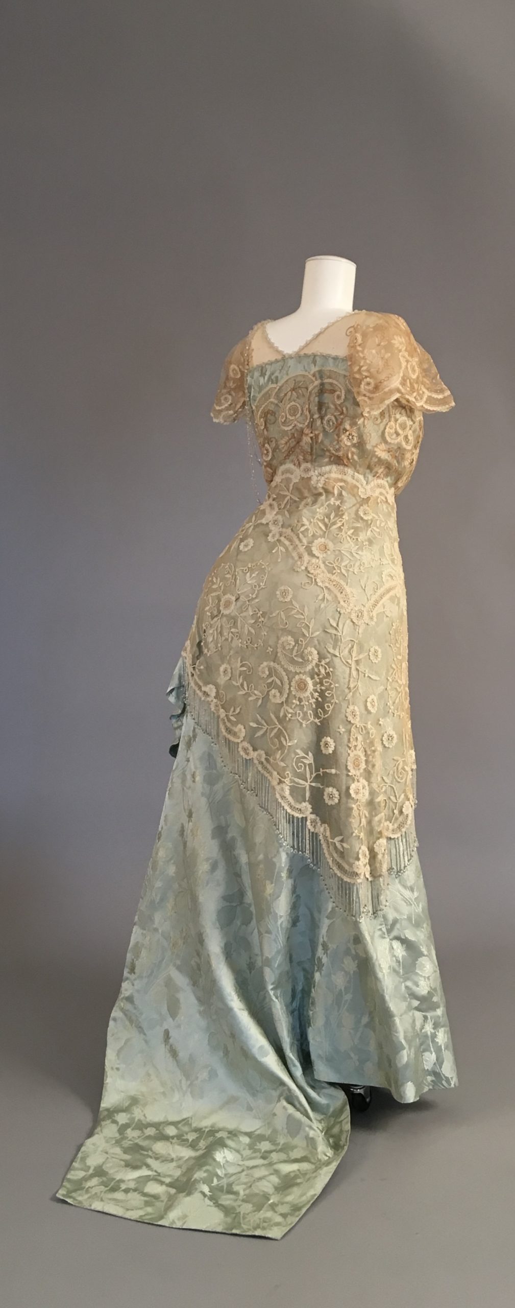 10 TITANIC 1910s ballgown, light blue-green brocade silk, and ivory lace, with beaded embelleshments.