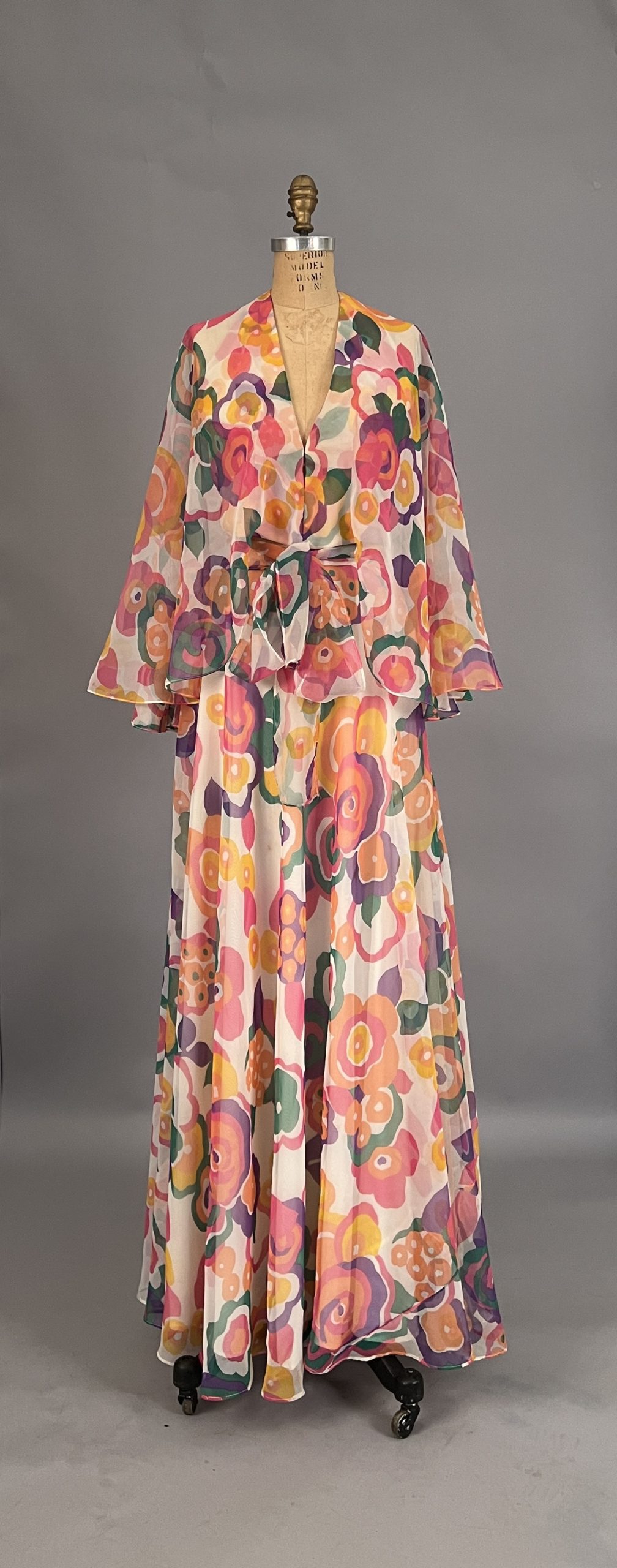 11 CAPRERO 73 1970s two piece Capero dress: Blouse and skirt of chiffon, floral patterns of pink, orange, green and purple.