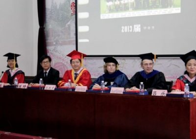 People sitting at a table. From left to right: Dean Qin LI, Vice Dean Qi Chen, Vice President Yuedong Sun, Provost Elizabeth Hendrey, Dr. Howard Kleinmann, Dean Le Lu