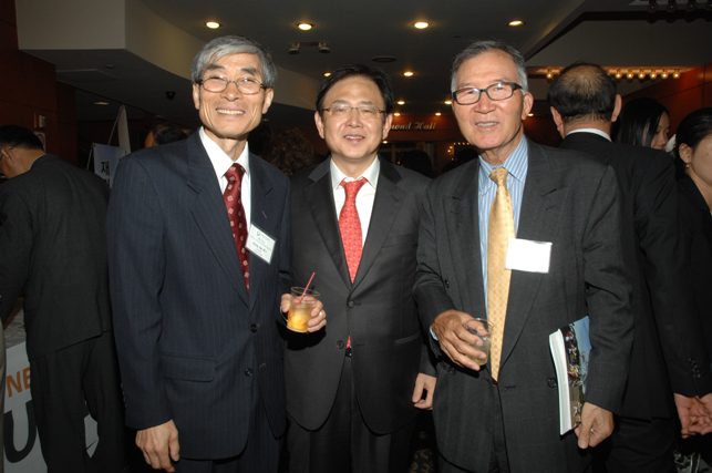 Three people pose for a group photo.