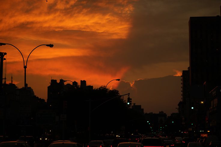 The view of the sky through a city street.