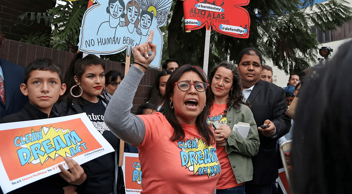 Cristina Jimenez, department alumna speaks to a crowd of activists