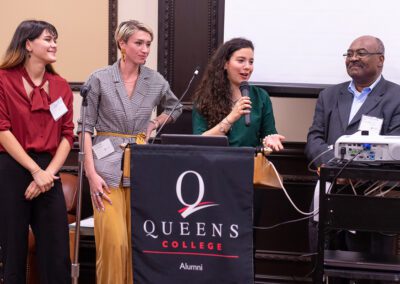 Members of QC's Award-Winning Model UN delegation (Anna Savva, Ardijana Kukic, and Angela Ramos-Santodomingo), speak during the 2019 PSCI Alumni Reception, alongside faculty advisor Prof. Pierre-Louis