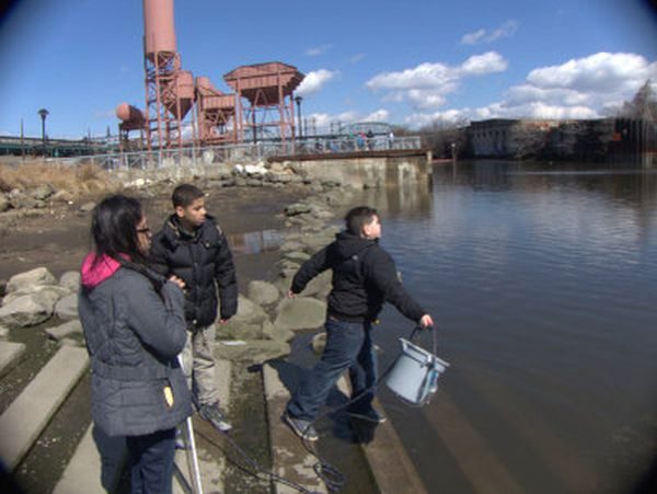 Students with a sample bucket for water analysis on the Bronx River.