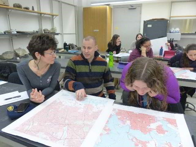 Three people looking at a map.