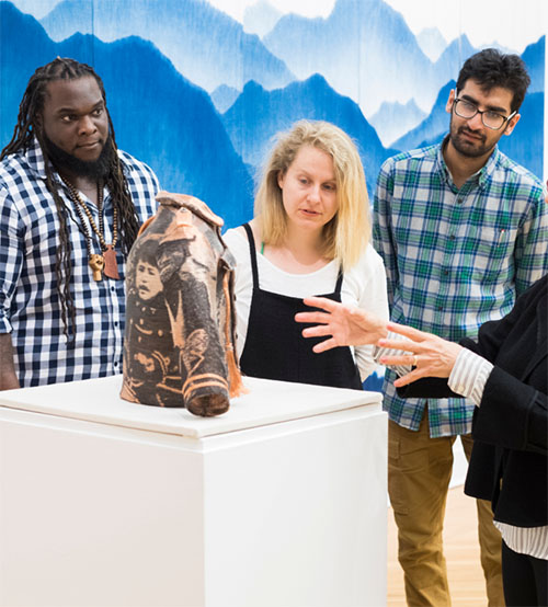 Three Art Students Looking at a Piece of Art