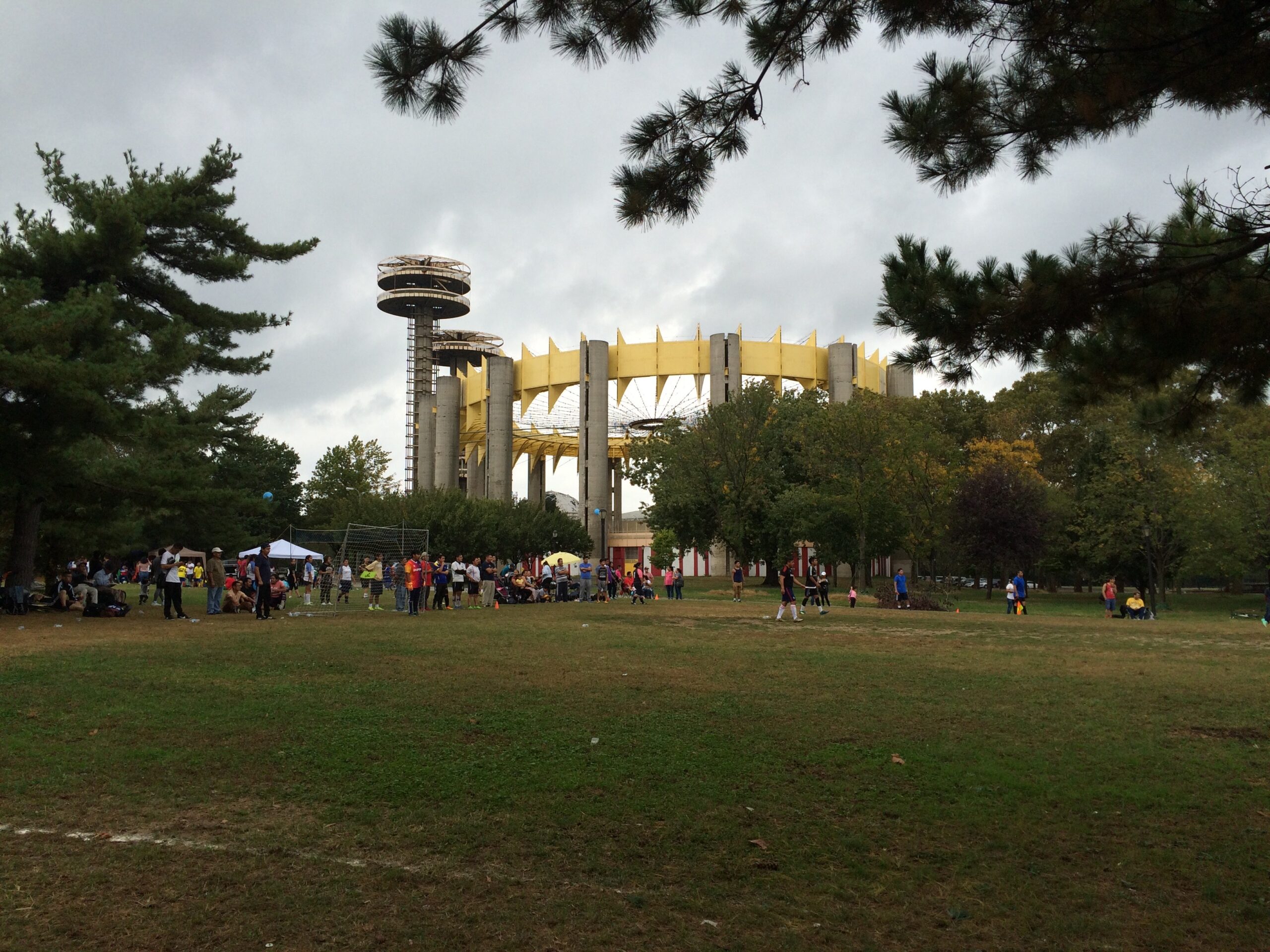 Soccer game in the foreground and the New York State Pavilion in the background.