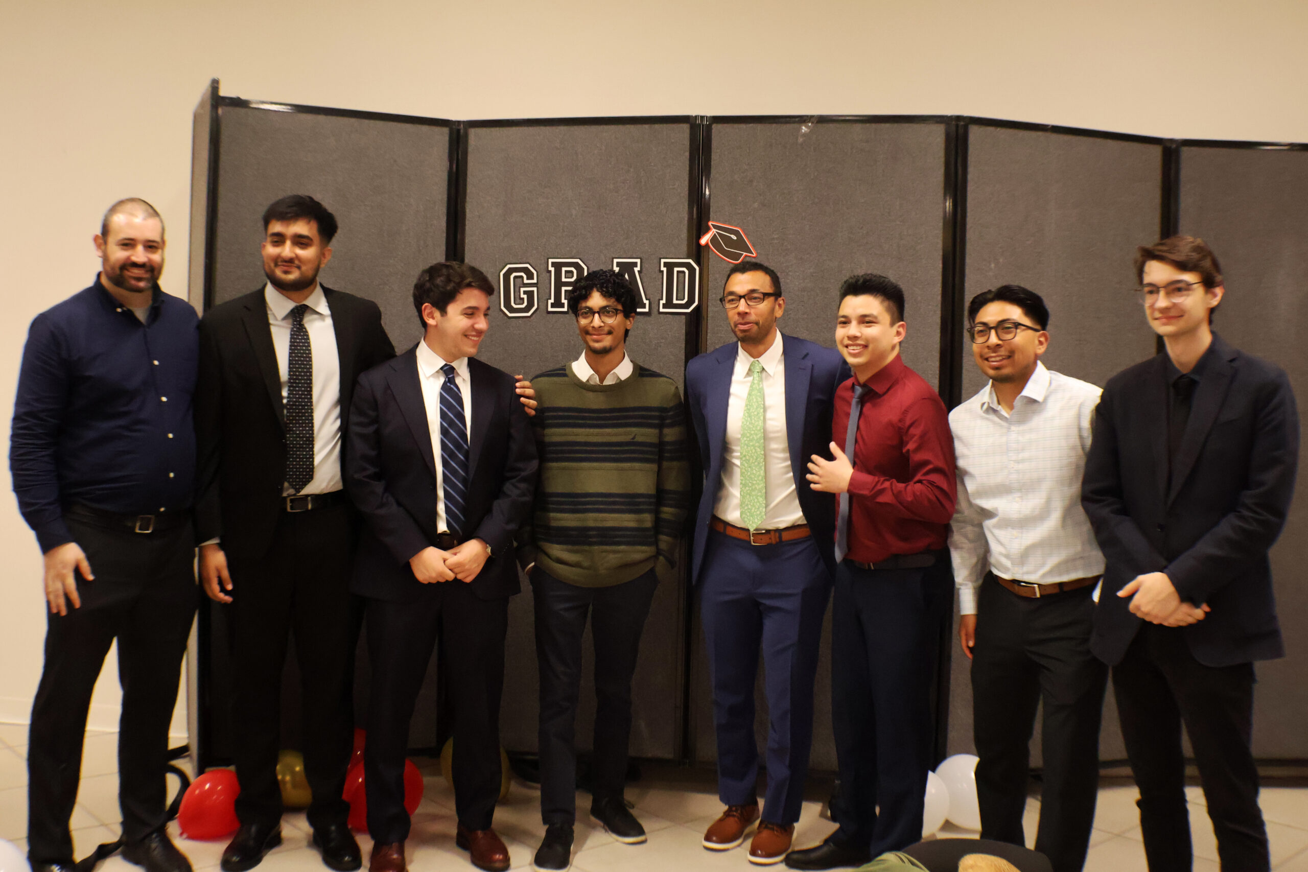 Eight people posing for the camera during the Graduate Award Ceremony.