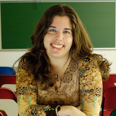 White woman with long hair and paisley shirt