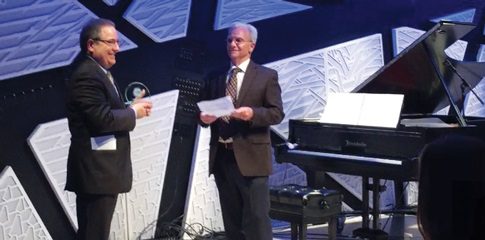 Edward Smaldone and Donald Pirone on a stage.