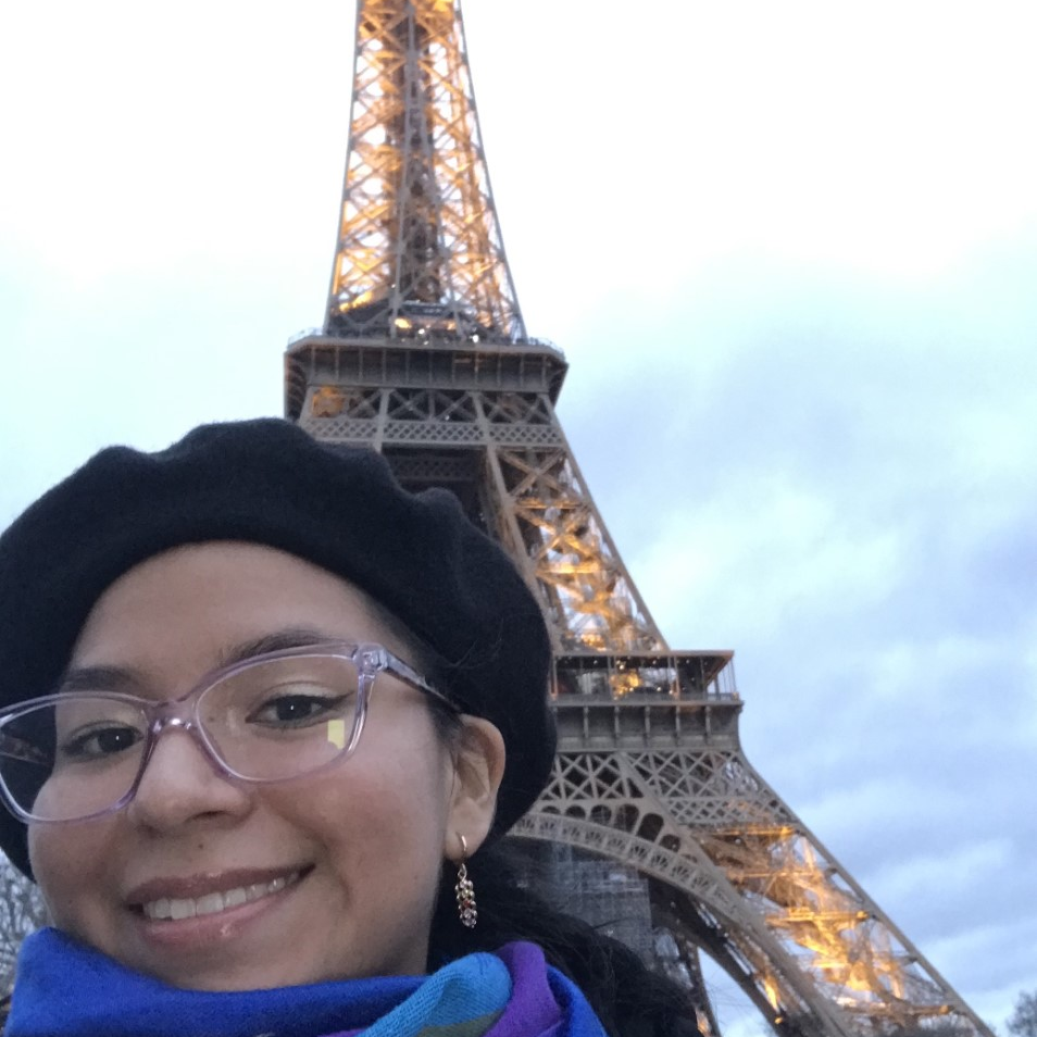Angie Calle Angie Calle in the foreground and the Eiffel tower in the background.