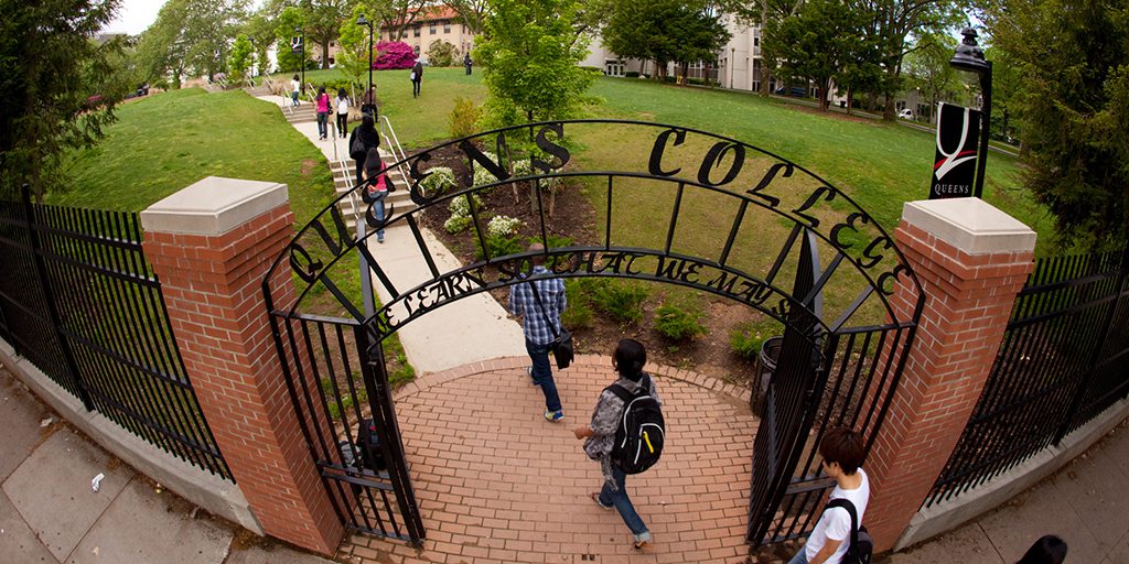 Students walking through the Queens College campus.