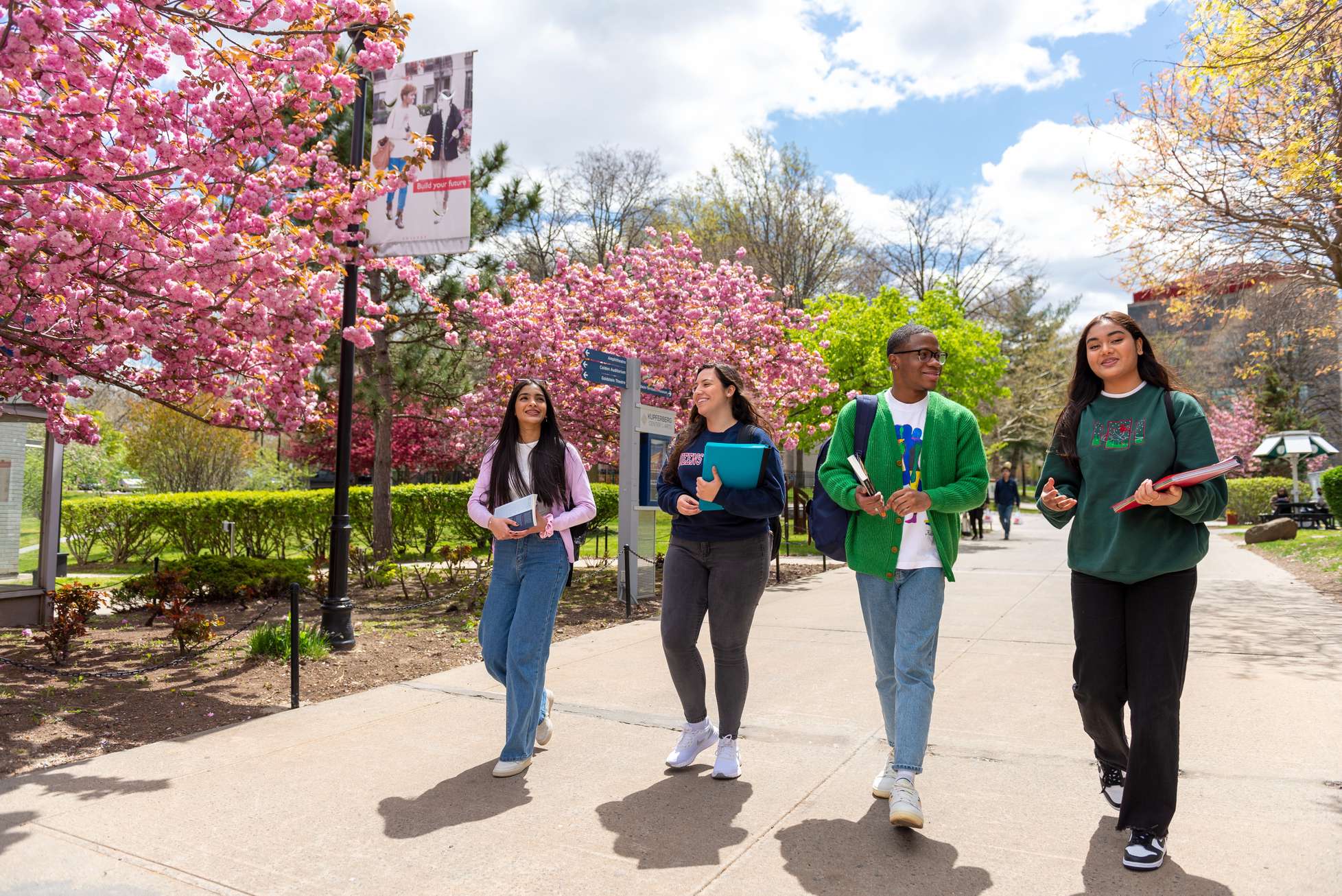 Students walking through the Queens College campus.