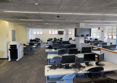 IB-200 computer lab with desks and computers before renovations.