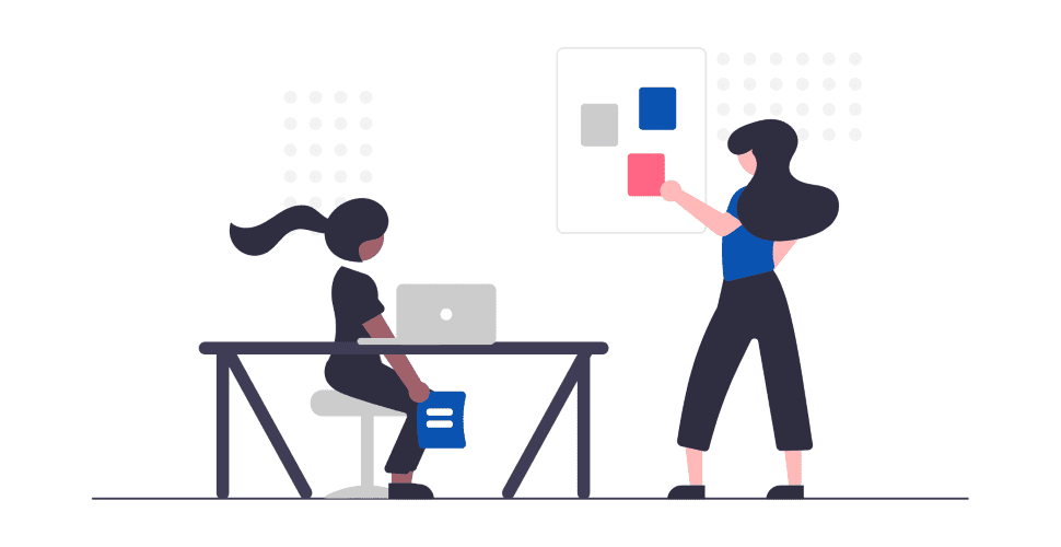 A person at a desk and another person presenting.