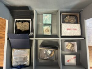 Open box showing objects from Barbara Rosenthal collection