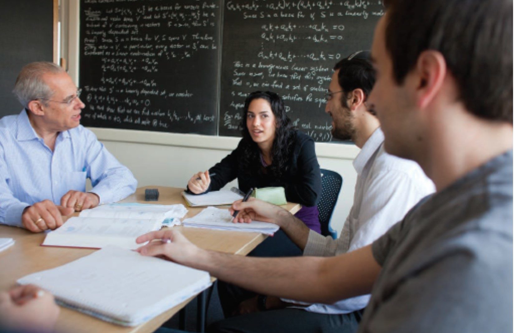 Classroom Discussion People sitting at table in conference room