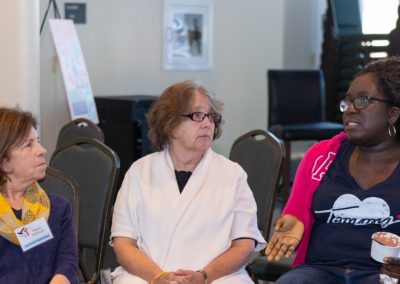 Three people sitting side-by-side having a conversation.