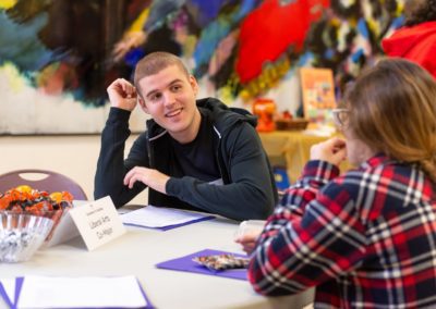 Two people having a conversation at a table.