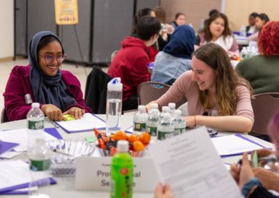 Two people sitting at a table laughing together.