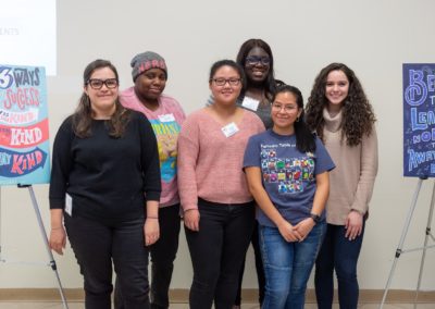 Six people standing together side-by-side.